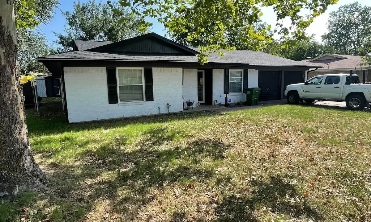 Professional roofing crew working on a residential roof in Naples